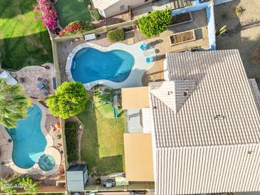 Stunning aerial view of a backyard with a private pool, garden, and lush landscaping, perfect for outdoor living at 780 S Lagoon Dr, Gilbert, AZ 85233