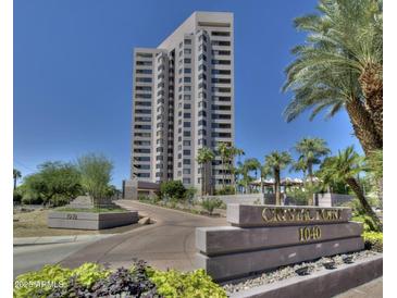 Modern condo building featuring a paved driveway, desert landscaping, and monument sign at 1040 E Osborn Rd # 1103, Phoenix, AZ 85014