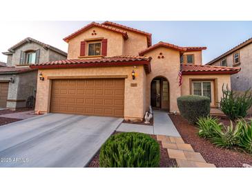 Charming two-story home with a well-maintained lawn, desert landscaping, and a two car garage at 10850 W Bronco Trl, Peoria, AZ 85383