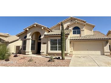 Charming single-Gathering home showcasing desert landscaping, a two-car garage, and beautiful architectural details at 11001 Clear Water --, Goodyear, AZ 85338