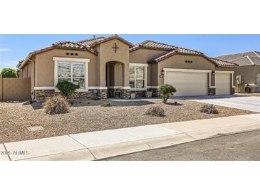 Charming single-story home with a well-manicured yard and a three car garage at 13811 W Paso Trl, Peoria, AZ 85383