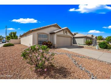 Charming single-story home with a two car garage, desert landscaping and covered entry at 16044 S 41St Pl, Phoenix, AZ 85048