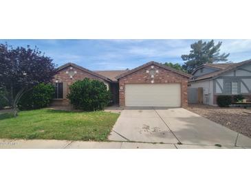 Charming single-story brick home with a well-manicured lawn and mature landscaping at 1835 E Cortez Dr, Gilbert, AZ 85234