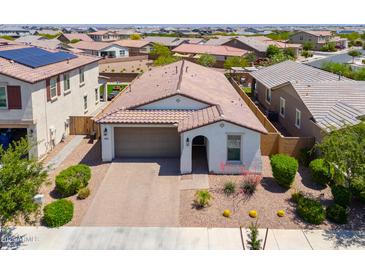 Inviting single-story home featuring a two-car garage, desert landscaping, and a charming covered entryway at 21595 S 225Th Way, Queen Creek, AZ 85142