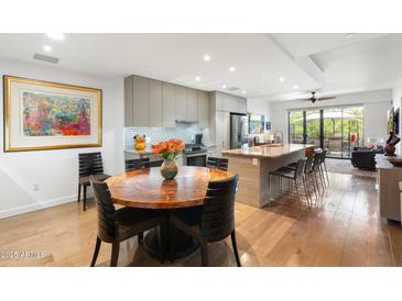 Bright, modern kitchen features stainless steel appliances and a large island with bar seating at 2300 E Campbell Ave # 104, Phoenix, AZ 85016