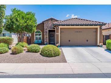 Charming single-story home with stone accents, a well-maintained front yard, and a two-car garage at 26071 W Sequoia Dr, Buckeye, AZ 85396