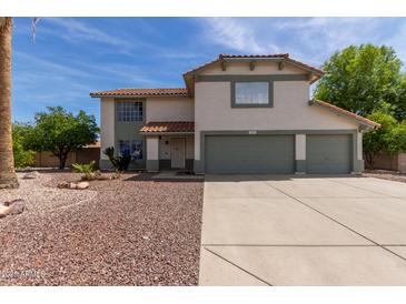 Charming two-story home featuring a well-maintained front yard and a spacious three-car garage at 2643 E Menlo St, Mesa, AZ 85213