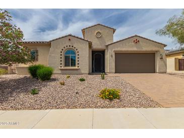 Charming single-story home with a two-car garage, desert landscaping, and a quaint architectural details at 26860 N 102Nd Ln, Peoria, AZ 85383