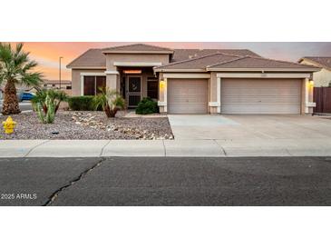 Charming home featuring a desert landscape, two-car garage, and tile roof against a beautiful sunset sky at 3256 E Maplewood St, Gilbert, AZ 85297