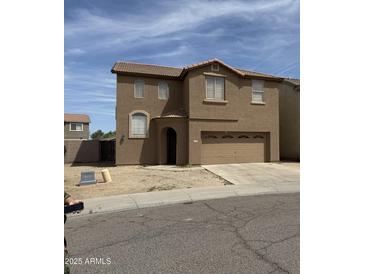 Charming two-story home featuring a two-car garage, low maintenance landscaping, and a tile roof at 3825 S 60 Dr, Phoenix, AZ 85043