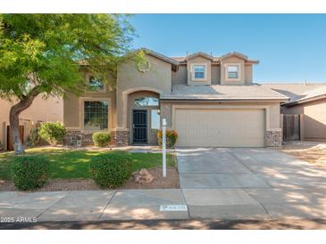 Charming two-story home with a well-manicured lawn and mature landscaping at 4030 E Prickly Pear Trl, Phoenix, AZ 85050