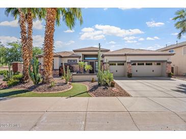 Beautiful desert home with a three-car garage, stone accents, and a meticulously landscaped front yard at 4589 N 154Th Ave, Goodyear, AZ 85395