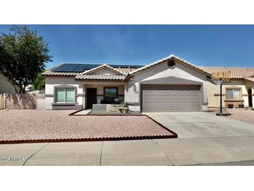 Charming single-story home with a well-maintained desert landscape and a two-car garage at 630 E Racine Pl, Casa Grande, AZ 85122
