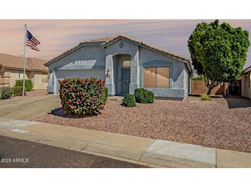 Charming single-story home featuring desert landscaping, covered entry, and an attached two-car garage at 13416 W Ventura St, Surprise, AZ 85379