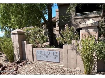 Villages North sign with address, 15225, surrounded by desert landscaping and multi-story condo buildings at 15225 N 100Th St # 1220, Scottsdale, AZ 85260