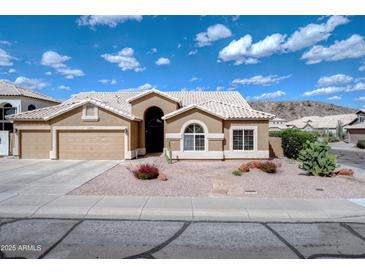 Charming single-story home featuring a stucco exterior, desert landscaping, and a two-car garage at 15273 S 31St St, Phoenix, AZ 85048