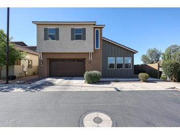 Two-story home featuring a two-car garage and a combination of stucco and wood siding at 1871 E Lantana Dr, Chandler, AZ 85286