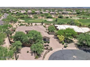 Expansive home with a tile roof is surrounded by mature landscaping and a golf course at 22463 N 54Th St, Phoenix, AZ 85054