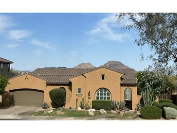 Charming single-story home featuring a well-maintained lawn, desert landscaping, and two car garage at 25943 N 84Th Dr, Peoria, AZ 85383