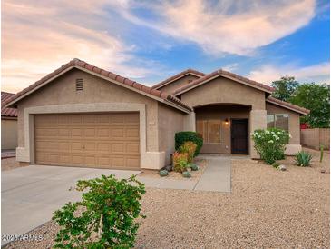 Inviting single-story home featuring a two-car garage and desert landscaping at 3604 W Calle Lejos --, Glendale, AZ 85310