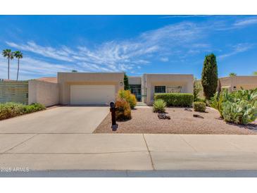 Charming single story home with desert landscaping, two car garage, and a private gated courtyard at 4317 E Glenrosa Ave, Phoenix, AZ 85018