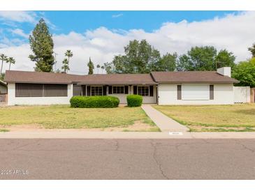 Charming single-story home featuring a well-maintained lawn and inviting curb appeal at 8121 N 8Th Ave, Phoenix, AZ 85021