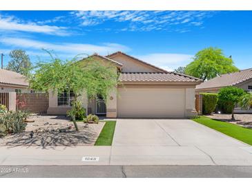 Charming single-story home featuring a well-maintained front yard and a two-car garage at 1049 N Monterey St, Gilbert, AZ 85233
