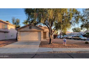 Charming single-story home featuring a low maintenance desert landscape and attached two-car garage at 10645 W Piccadilly Rd, Avondale, AZ 85392