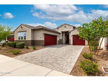 Charming single-story home with a three-car garage, paver driveway, and well-maintained desert landscaping at 13228 W Buckskin Trl, Peoria, AZ 85383