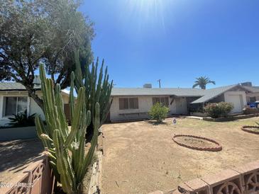 Charming single-story home with desert landscaping and brick accents at 1529 W Eva St, Phoenix, AZ 85021