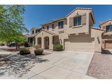 Beautiful two-story home featuring a tile roof, two-car garage, and inviting entryway at 15420 W Canterbury Dr, Surprise, AZ 85379