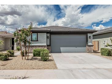 Charming single-Gathering home showcases a two-car garage and low-maintenance landscaping for easy living at 17376 W Via De Luna Dr, Surprise, AZ 85387
