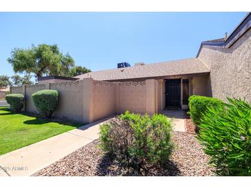 Charming single-story home featuring a private front entrance with a landscaped walkway at 17802 N 45Th Ave, Glendale, AZ 85308