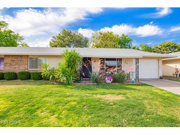 Charming single-story home with a well-maintained lawn and mature landscaping at 17804 N Del Webb Blvd, Sun City, AZ 85373