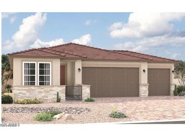 Charming single-story home featuring a two-car garage, landscaped front yard, and a stylish tiled roof at 18210 W Hess St, Goodyear, AZ 85338