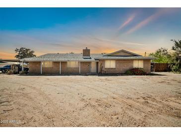 Charming single-story brick home with a well-maintained exterior and desert landscaping at 2024 N 200Th Ave, Buckeye, AZ 85396