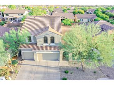 This aerial view displays the home's exterior, terracotta roof, desert landscaping, and wide driveway at 2211 W Desert Ln, Phoenix, AZ 85041