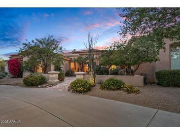 Inviting single-Gathering home showcasing desert landscaping and a warm, tranquil ambiance under the evening sky at 24158 N 78Th Pl, Scottsdale, AZ 85255