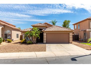 Charming single-story home featuring a tile roof, desert landscaping, and a two-car garage at 2503 E Camellia Dr, Gilbert, AZ 85296