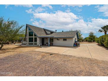 Spacious single story home with large paved driveway and unique stonework details and large windows at 37414 N 17Th Ave, Phoenix, AZ 85086