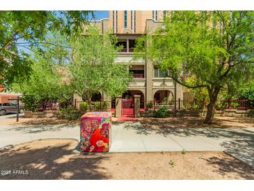 Charming building exterior with well-maintained landscaping and secure gated entry at 387 N 2Nd Ave # F2, Phoenix, AZ 85003