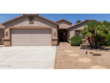 Charming single-Gathering home with desert landscaping, covered entry, and a two-car garage at 43344 W Oster Dr, Maricopa, AZ 85138