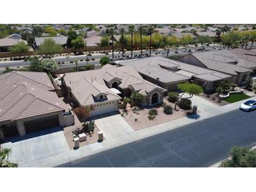 An aerial view of a single Gathering home that features a landscaped front yard and an attached two-car garage at 16083 W Cambridge Ave, Goodyear, AZ 85395