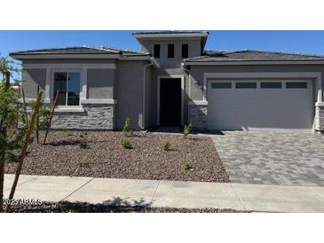 Charming single-story home featuring stone accents, desert landscaping, and a spacious two-car garage at 16550 W Creedance Blvd, Surprise, AZ 85387