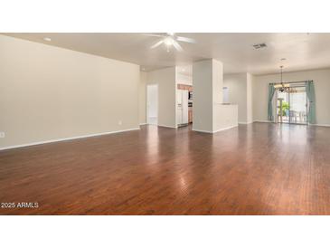 Spacious living room with hardwood floors, ceiling fan, and sliding glass doors at 16848 W Rimrock St, Surprise, AZ 85388