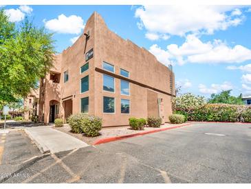Attractive two-story stucco building with large windows, landscaping, and assigned parking spots at 1718 W Colter St # 195, Phoenix, AZ 85015