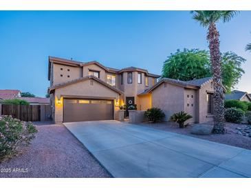 Charming two-story home with a well-maintained lawn and a spacious driveway leading to a two-car garage at 3901 E Packard Dr, Gilbert, AZ 85298