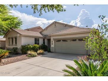 Charming single-story home featuring a two-car garage, well-maintained landscaping, and a welcoming entrance at 4335 E Sleighbell Dr, Gilbert, AZ 85297