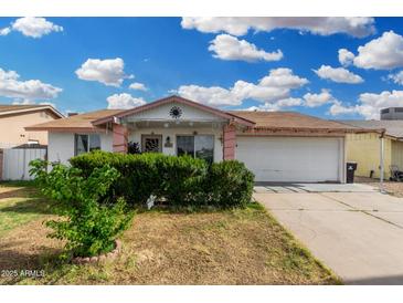 Charming single-story home with a well-maintained front yard and attached two-car garage at 4513 W Yucca St, Glendale, AZ 85304