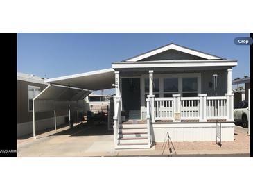 Charming home exterior with covered carport, covered front porch and desert landscaping at 8700 E University Dr # 124, Mesa, AZ 85207